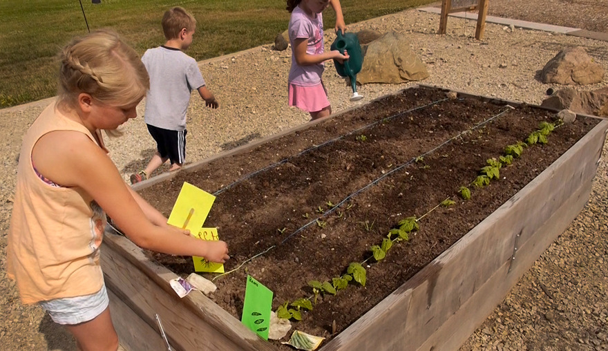 kids watering planter Lake Harriet