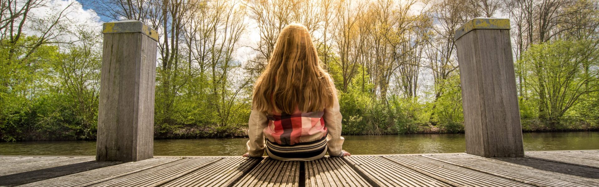 girl sitting on dock